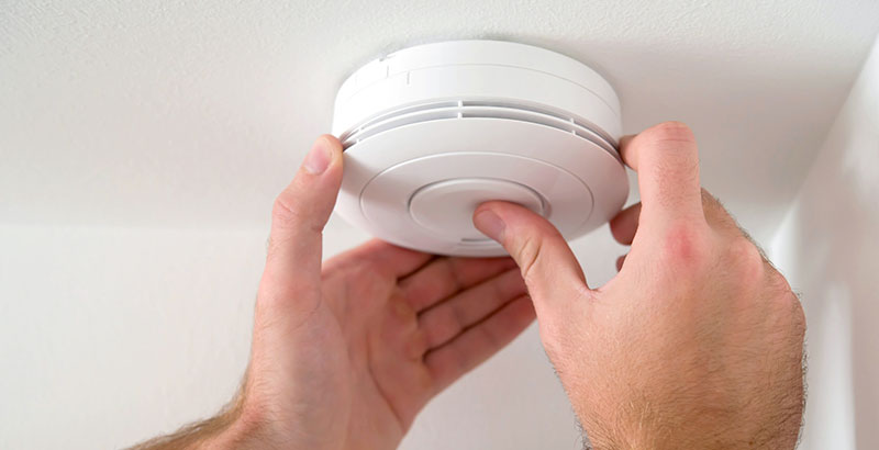 Smoke alarm being tested during Sydney home electrical safety inspection